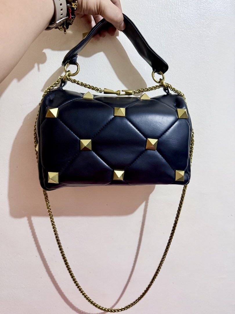 Valentino Garavani Studded Two-Way Bag (Category: Luxury Bags & Wallets) located in Cavite. Submitted by lady_speculator_ph (Listing ID 1439683779, Image 2). Description: - Japan sourced from my personal SA, not ukay - Black color - Handbag with original metal sling, can be used as a shoulder bag - Gold-tone hardware and studded details - Chain strap and top handle - Valentino Garavani label inside - Coded - Signs of use: Minor exterior wear and 