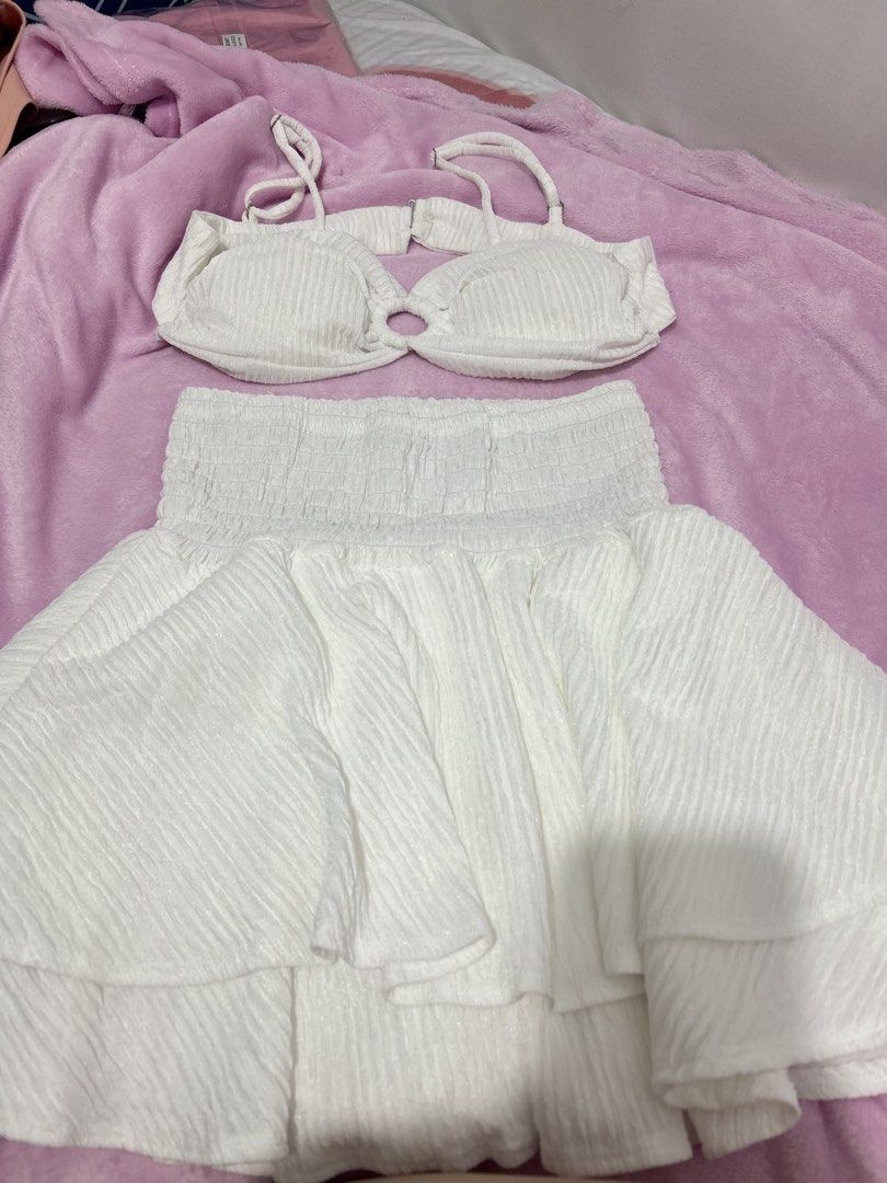 White Bikini Top and Skirt Set (Category: Bikinis & Swimsuits) located in Manila. Submitted by aliepreloved (Listing ID 1439730051, Image 1). Description: - White bikini set - Keyhole bikini top - Matching tiered skirt - Smocked waistband - Textured, ribbed fabric - Ideal for beach or summer trips.