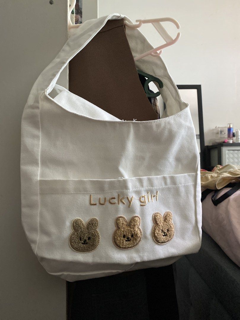 White Canvas Tote Bag with Bear Design Cute bah (Category: Tote Bags) located in Las Pinas. Submitted by declutterwithakii (Listing ID 1439636699, Image 1). Description: - White canvas tote bag - Adorable bear design - Front pocket for easy access - Secure zipper closure - Comfortable single shoulder strap - Clean interior - Perfect for daily essentials.