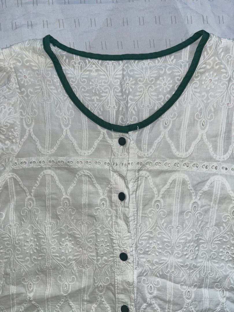 ST33 White Embroidered Blouse with Green Trim (Category: Blouses) located in Marikina City. Submitted by namicorner (Listing ID 1439634408, Image 2). Description: - White blouse with delicate embroidery - Features a scalloped hem - Short, puffy sleeves - Round neckline with green trim - Button-down front - Lightweight fabric, ideal for warm weather - Versatile style: dress it up or down.