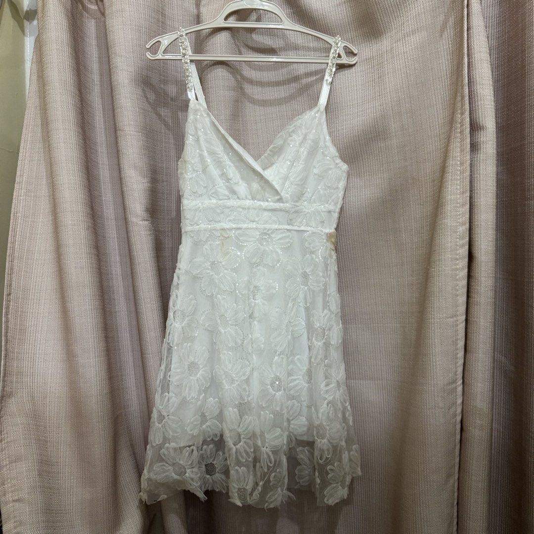 White Floral Mini Dress (Category: Dresses) located in Manila. Submitted by miss.v.declutter (Listing ID 1439769339, Image 1). Description: - Has a stain but washable - Minor flaw on left strap.