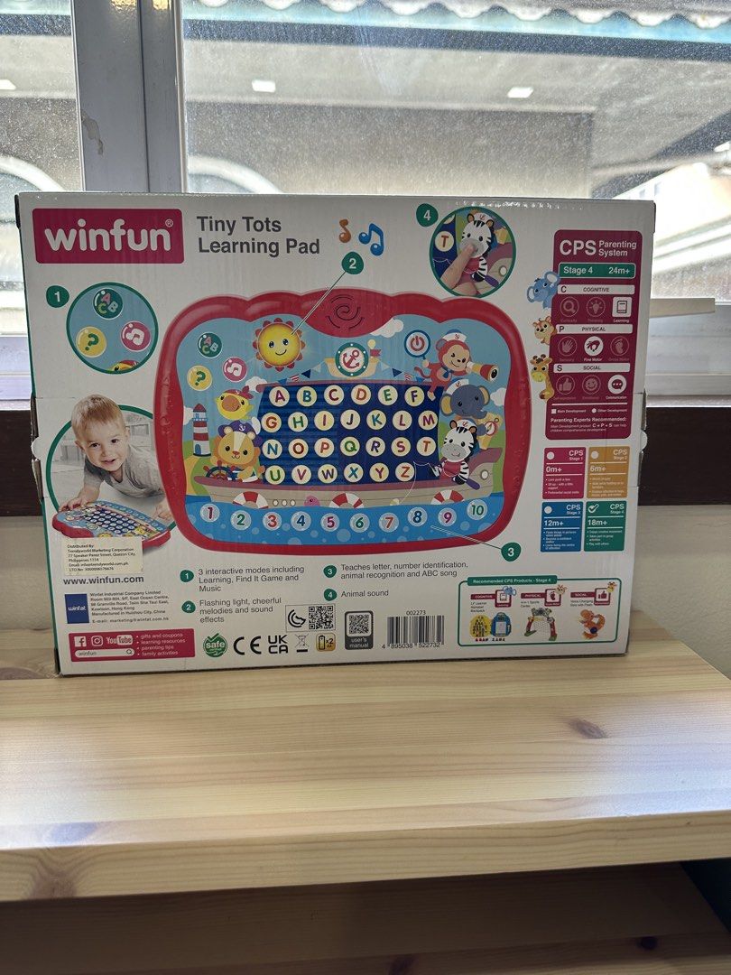 WinFun Tiny Tots Learning Pad (Category: Educational & Learning Toys) located in Quezon City. Submitted by things2things (Listing ID 1439656372, Image 2). Description: - WinFun Tiny Tots Learning Pad for early learning. - 3 Interactive Modes: Learning, Find It Game, Animal Sounds. - Teaches: Letters, Numbers, Animal Recognition, ABC Songs. - 150+ Fun Sounds and Melodies. - Suitable for Stage 4 (24+ months)..