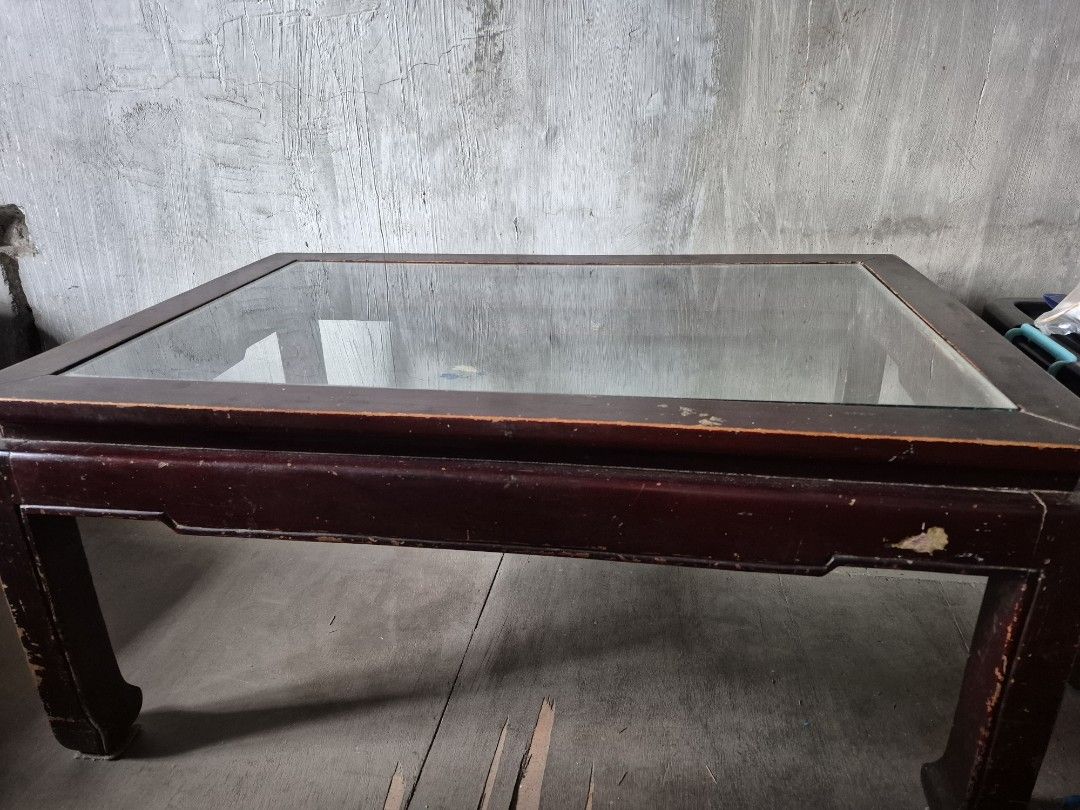 Wooden Coffee Table with Glass Top (Category: Tables & Sets) located in Bacoor. Submitted by Talsp (Listing ID 1439742997, Image 2). Description: Made from Narra tree. It is heavy and need 2 people to carry it. - Dark wooden frame - Clear glass top - Rectangular shape - Sturdy base - Classic design - Ideal for living room use - Well-constructed.