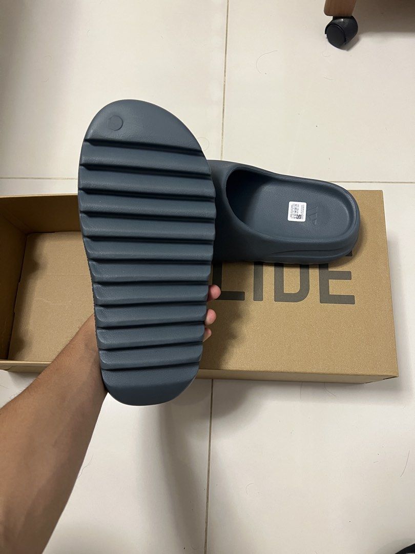 Yeezy slides (Category: Flipflops and Slides) located in Singapore. Submitted by sneakyjuicy (Listing ID 1439781877, Image 2). Description: Brand new yeezy slides slate marine Us10 Unworn Selling cheap because its now my size Brought it in vietname.