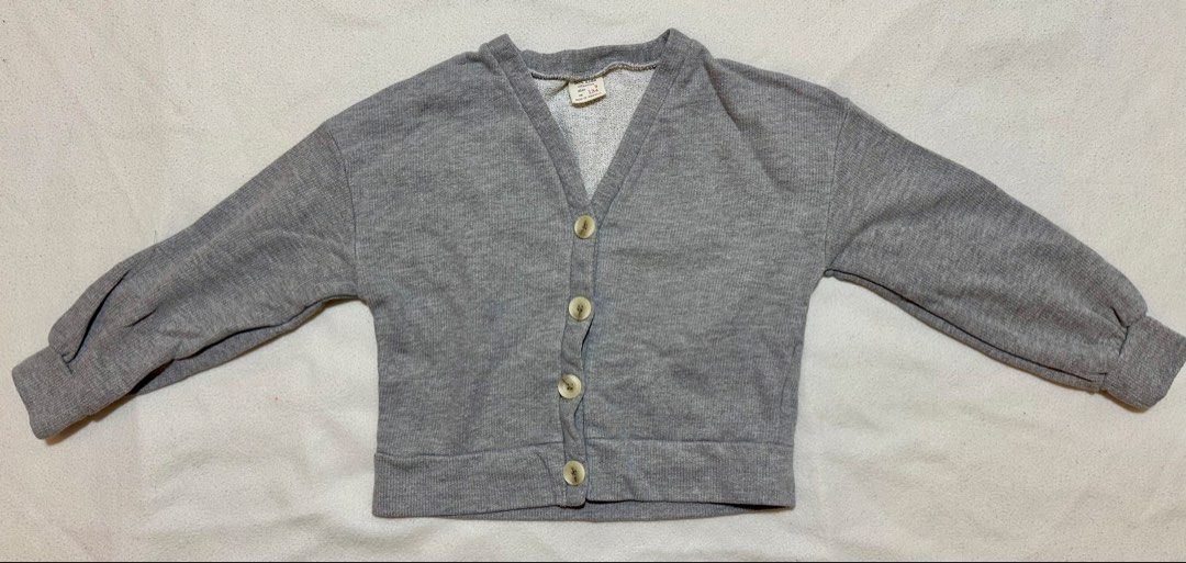 Zara Kids Grey Cardigan Size 9 (Category: Babies & Kids Fashion) located in Mandaluyong City. Submitted by toront0427 (Listing ID 1439747439, Image 1). Description: - Zara Kids grey cardigan - Size: 9 - Features: V-neck, button closure - Made in Portugal - Long sleeves with ribbed cuffs - Comfortable and versatile.