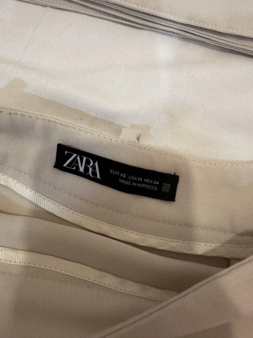 Zara Mini Skirt with Belt (Category: Skirts) located in Quezon City. Submitted by insidecloset.c (Listing ID 1439785799, Image 2). Description: - Original Zara cream skirt - Includes matching belt - Size: XS - Features a flared hem - With belt loops, buckle closure, and shorts RFS: too small already .