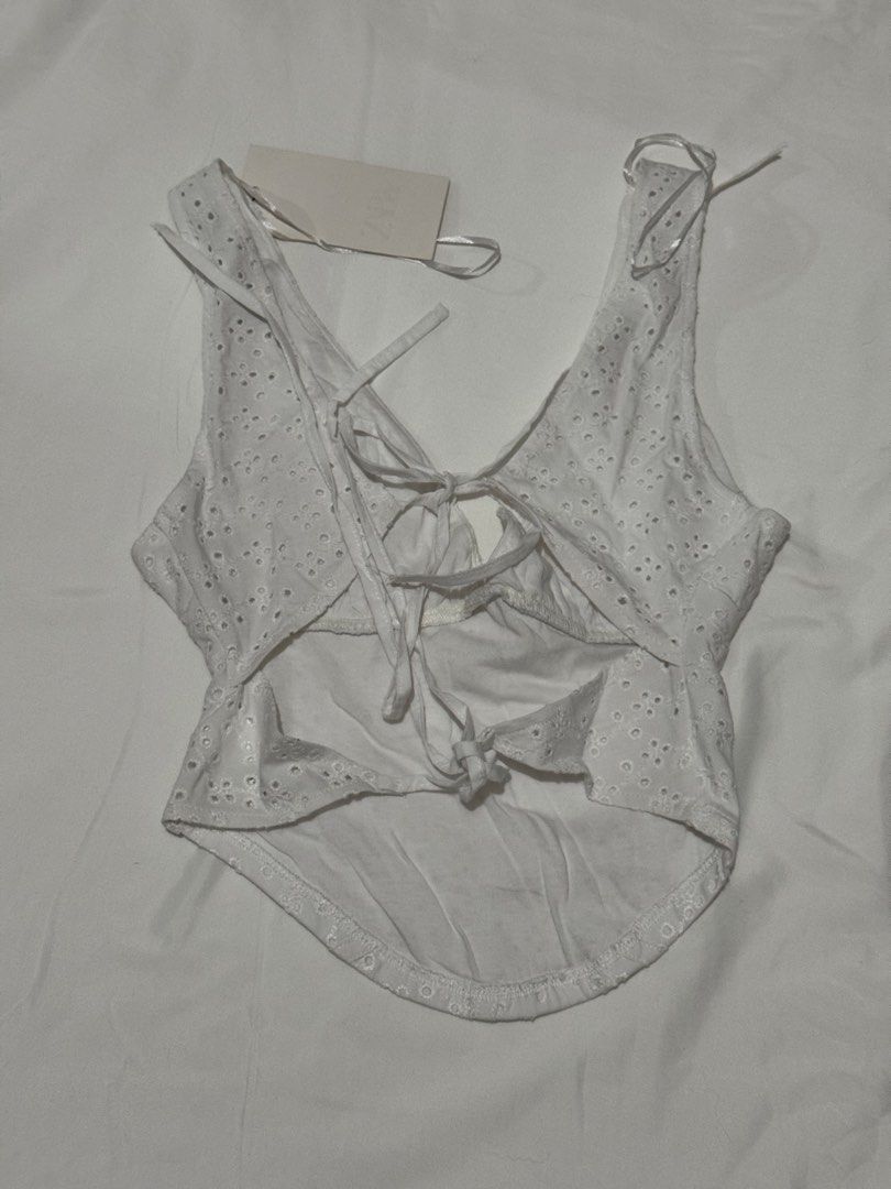 Zara White Eyelet Corset Tie-Back Top (Category: Sleeveless) located in Cavite. Submitted by ellieschoice (Listing ID 1439668924, Image 2). Description: For reference, I usually get xs sa zara pero hanggang small lang yung size for this top I have a similar white eyelet dress so I'm selling this na.