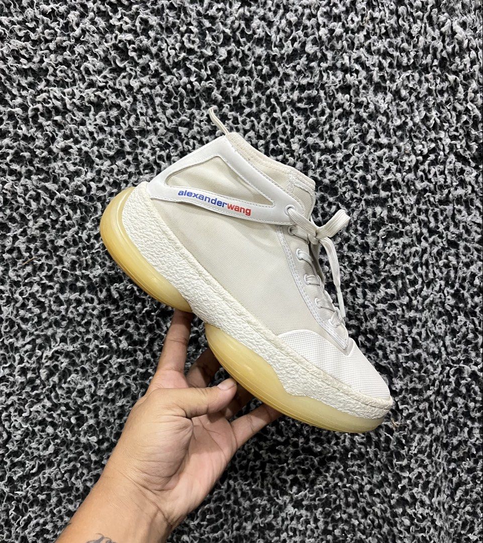 Alexander Wang A1 Logo High-Top Sneaker. | Size 43 (Category: Sneakers) located in General Trias. Submitted by zrchustle.604 (Listing ID 1439858972, Image 1). Description: the Alexander Wang A1 Logo High-Top Sneaker. Key Features Silhouette: Paneled mid-to-high top construction featuring a mixed-material upper made of breathable mesh and leather overlays. Sole: Distinguishable chunky, bubble-like translucent rubber platform sole with textured fox