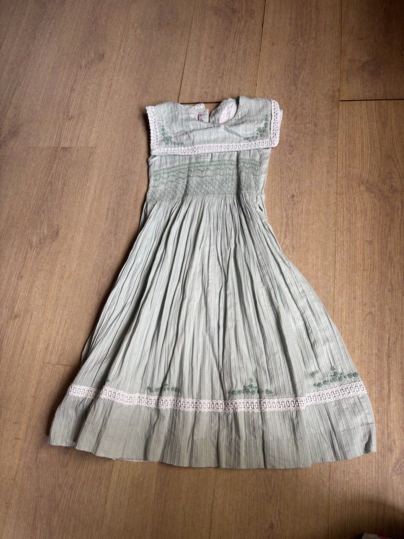 Smocked Green Dress Size 8 (Category: Babies & Kids Fashion) located in Cebu City. Submitted by limjennif52235 (Listing ID 1439824144, Image 1). Description: - Ana Rosa green dress - Intricate embroidery and lace detailing - Pleated skirt - Fitted bodice - Round neckline, sleeveless - Size 8 - Perfect for special occasions or everyday wear.