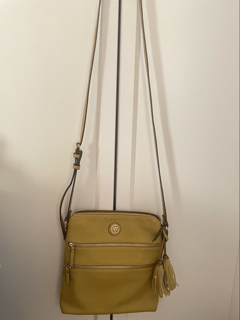 Anne Klein Mustard Crossbody Bag (Category: Cross-body Bags) located in Quezon City. Submitted by jeffs_thriftshop (Listing ID 1439863050, Image 1). Description: - Anne Klein crossbody bag - mustard color - Multiple zippered compartments - Stylish tassel detail - Adjustable strap for a perfect fit - Made of textured material - Features the Anne Klein logo Issues: slight chafing see details in pictures.