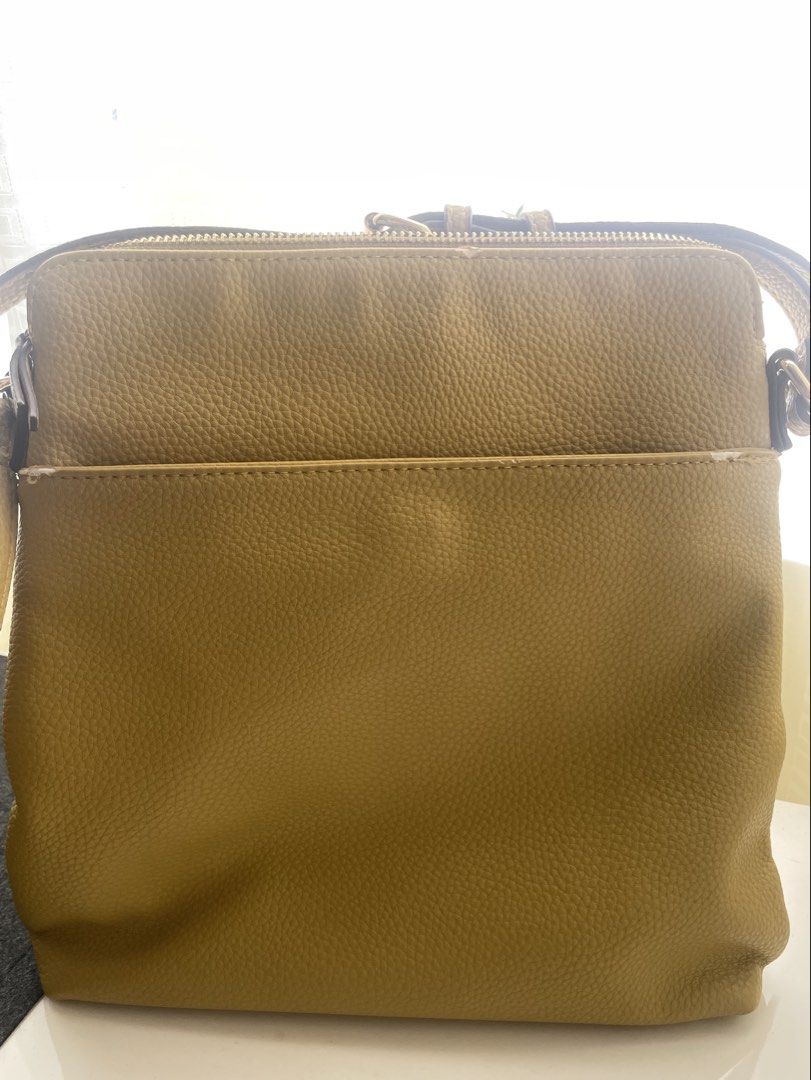 Anne Klein Mustard Crossbody Bag (Category: Cross-body Bags) located in Quezon City. Submitted by jeffs_thriftshop (Listing ID 1439863050, Image 2). Description: - Anne Klein crossbody bag - mustard color - Multiple zippered compartments - Stylish tassel detail - Adjustable strap for a perfect fit - Made of textured material - Features the Anne Klein logo Issues: slight chafing see details in pictures.