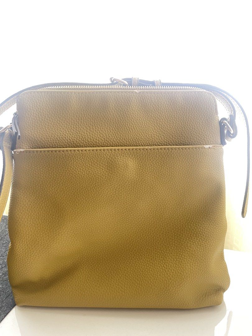 Anne Klein Mustard Crossbody Bag (Category: Cross-body Bags) located in Quezon City. Submitted by jeffs_thriftshop (Listing ID 1439863050, Image 3). Description: - Anne Klein crossbody bag - mustard color - Multiple zippered compartments - Stylish tassel detail - Adjustable strap for a perfect fit - Made of textured material - Features the Anne Klein logo Issues: slight chafing see details in pictures.