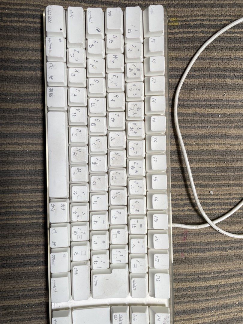 Apple Wired Keyboard with Numeric Keypad (Category: Computer Keyboard) located in Quezon City. Submitted by eilgaraje (Listing ID 1439844478, Image 2). Description: - Apple wired keyboard with numeric keypad - White finish - Includes USB cable - Some keys show wear and tear - Features Japanese characters - Model: A1243 - Includes original cable.