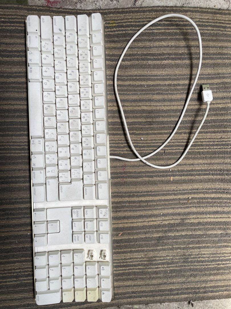 Apple Wired Keyboard with Numeric Keypad (Category: Computer Keyboard) located in Quezon City. Submitted by eilgaraje (Listing ID 1439844478, Image 1). Description: - Apple wired keyboard with numeric keypad - White finish - Includes USB cable - Some keys show wear and tear - Features Japanese characters - Model: A1243 - Includes original cable.