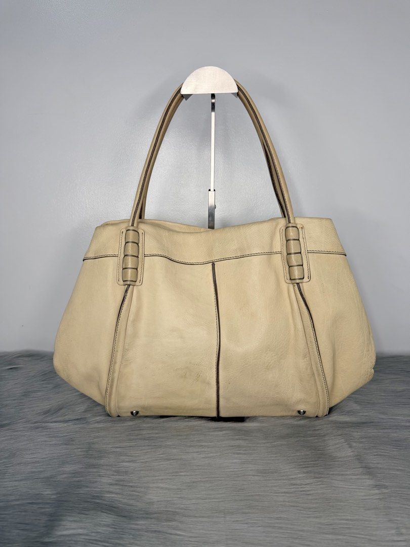 TOD’S Shade Tote Leather Bag (Category: Luxury Bags & Wallets) located in Quezon City. Submitted by madame_bagelia_collection (Listing ID 1439865628, Image 3). Description: 🔸Authentic 💯 🔸Preloved 🔸Rank A- Almost New Condition 🔸Sign of use: Minimal color stain on leather (back part) & ink stain on interior lining. Kindly check photos. 🔸Genuine leather 🔸Silver color hardwares 🔸Magnetic button closure 🔸Fully lined interior 🔸Has 1 zip inter