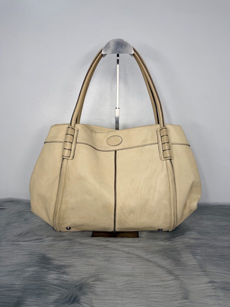 TOD’S Shade Tote Leather Bag (Category: Luxury Bags & Wallets) located in Quezon City. Submitted by madame_bagelia_collection (Listing ID 1439865628, Image 2). Description: 🔸Authentic 💯 🔸Preloved 🔸Rank A- Almost New Condition 🔸Sign of use: Minimal color stain on leather (back part) & ink stain on interior lining. Kindly check photos. 🔸Genuine leather 🔸Silver color hardwares 🔸Magnetic button closure 🔸Fully lined interior 🔸Has 1 zip inter
