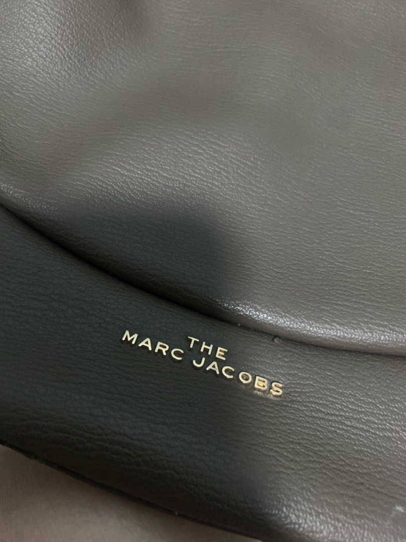 Authentic The Marc Jacobs Crescent/Eclipse Bag (Category: Luxury Bags & Wallets) located in Manila. Submitted by clarisse.preloved (Listing ID 1439968950, Image 2). Description: -Authentic Marc Jacobs Eclipse bag -Used with visible leather cracking/peeling on edges (see photos). -Hardware, zipper, and strap all working well. -No rust/tarnish. -Comes with original dust bag. -Great everyday/Y2K shoulder bag..