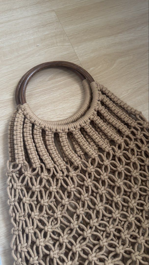 Bali Macrame Handbag with Wooden Handle (Category: Beach Bags) located in Paranaque City. Submitted by migvee (Listing ID 1439852881, Image 3). Description: - Macrame handbag - Unique woven design - Wooden handle - Fringe detail - Neutral tan color Length: ~48cm or ~19” Perfect for the beach or summer outings!.