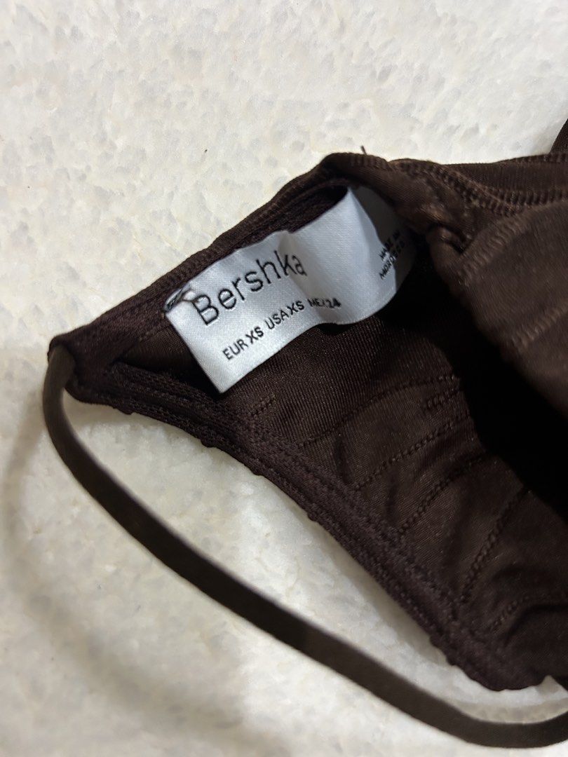 Bershka Brown One-Shoulder Ruched Crop Top (Category: Sleeveless) located in Bambang. Submitted by weeeyyaaa (Listing ID 1439930749, Image 3). Description: - Brand: Bershka - Color: Brown - Style: Crop Top - Design: One-shoulder, long sleeves - Details: Ruched all over, textured wavy pattern, metal ring accent on strap - Occasion: Night out, fashionable casual look.