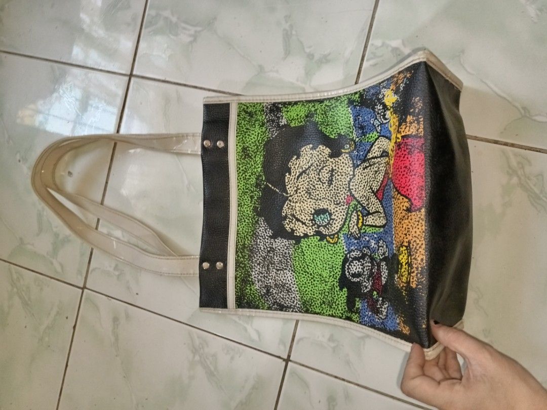 Betty Boop Tote Bag (Category: Tote Bags) located in Manila. Submitted by caaths_collection (Listing ID 1439879031, Image 2). Description: - Betty Boop design on the front - Black sides and bottom - White trim and handles - Made of a leather-like material - Rectangular shape - Original Betty Boop Tote Bag.