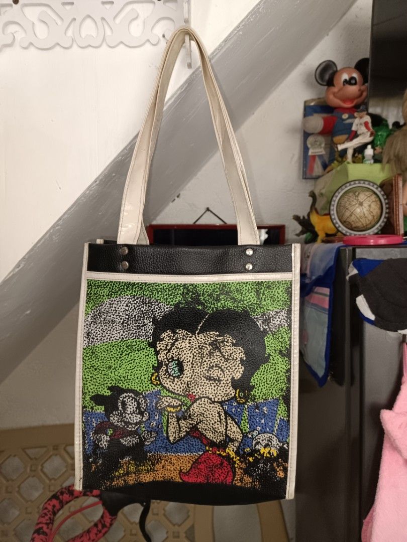 Betty Boop Tote Bag (Category: Tote Bags) located in Manila. Submitted by caaths_collection (Listing ID 1439879031, Image 1). Description: - Betty Boop design on the front - Black sides and bottom - White trim and handles - Made of a leather-like material - Rectangular shape - Original Betty Boop Tote Bag.