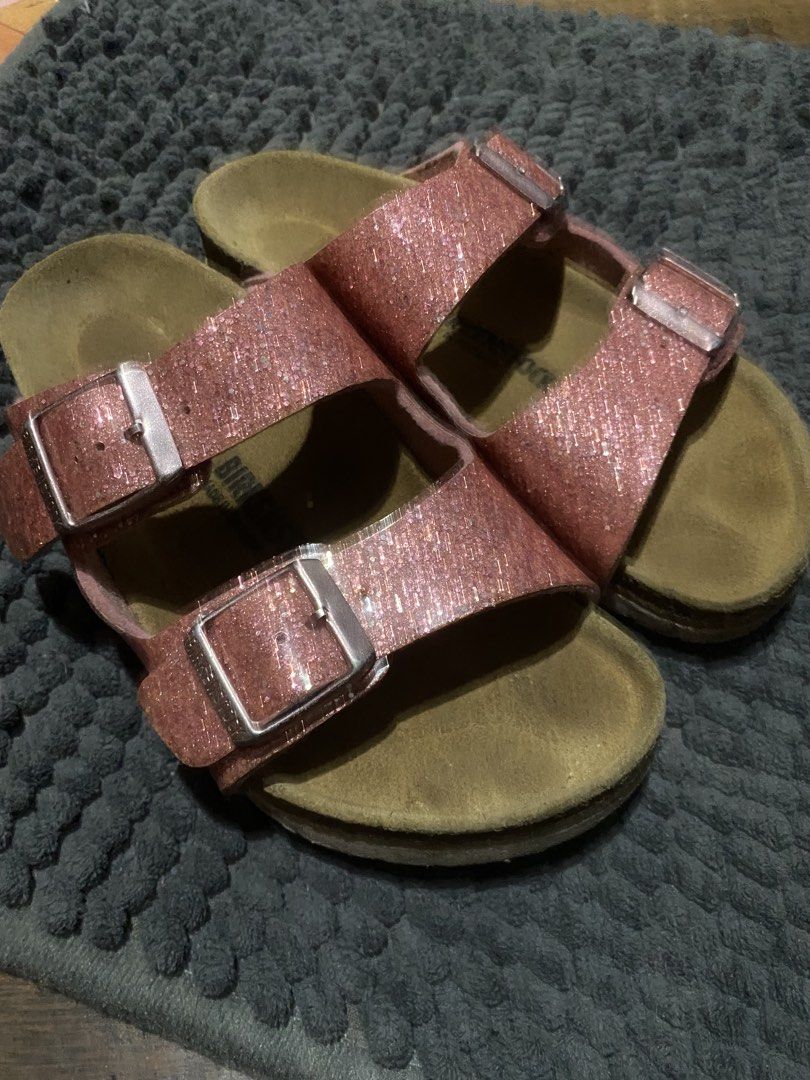 Birkenstock Glitter Sandals Rose Gold (Category: Babies & Kids Fashion) located in Manila. Submitted by chiik4y_thriftz (Listing ID 1439934672, Image 1). Description: - Sparkling rose gold glitter finish - Classic two-strap Birkenstock design - Adjustable buckles for a custom fit - Contoured cork footbed for excellent support - Adds glamour to any casual outfit.