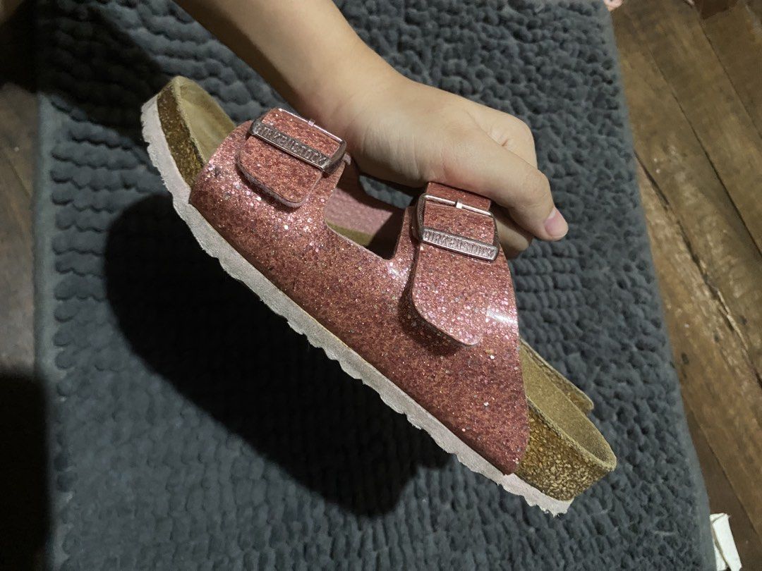 Birkenstock Glitter Sandals Rose Gold (Category: Babies & Kids Fashion) located in Manila. Submitted by chiik4y_thriftz (Listing ID 1439934672, Image 2). Description: - Sparkling rose gold glitter finish - Classic two-strap Birkenstock design - Adjustable buckles for a custom fit - Contoured cork footbed for excellent support - Adds glamour to any casual outfit.