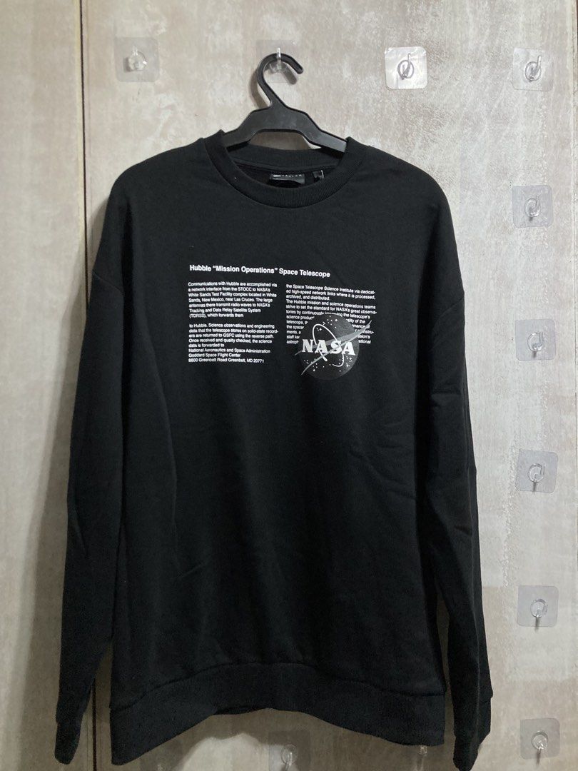 Black NASA Hubble Mission Operations Sweatshirt (Category: Coats, Jackets and Outerwear) located in Iloilo. Submitted by __kyleeee__ (Listing ID 1439918694, Image 1). Description: - Black long-sleeved sweatshirt - Features NASA Hubble Mission Operations Space Telescope graphic print - Includes text details and NASA logo on the front - Comfortable and stylish for casual wear.