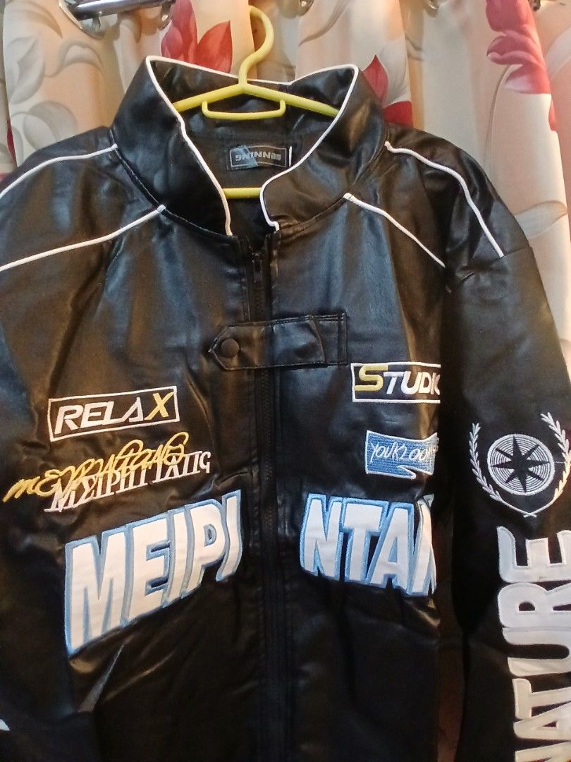 Black Racing Jacket with "Nature" and "Meipi" Graphics (Category: Coats, Jackets and Outerwear) located in Manila. Submitted by jaypeealb14603 (Listing ID 1439967997, Image 2). Description: - Stylish black racing jacket - Bold white and blue graphics - Features text: "Nature", "Studio", "Relax", "Meipi" - White piping accents - Perfect for a sporty and edgy look.