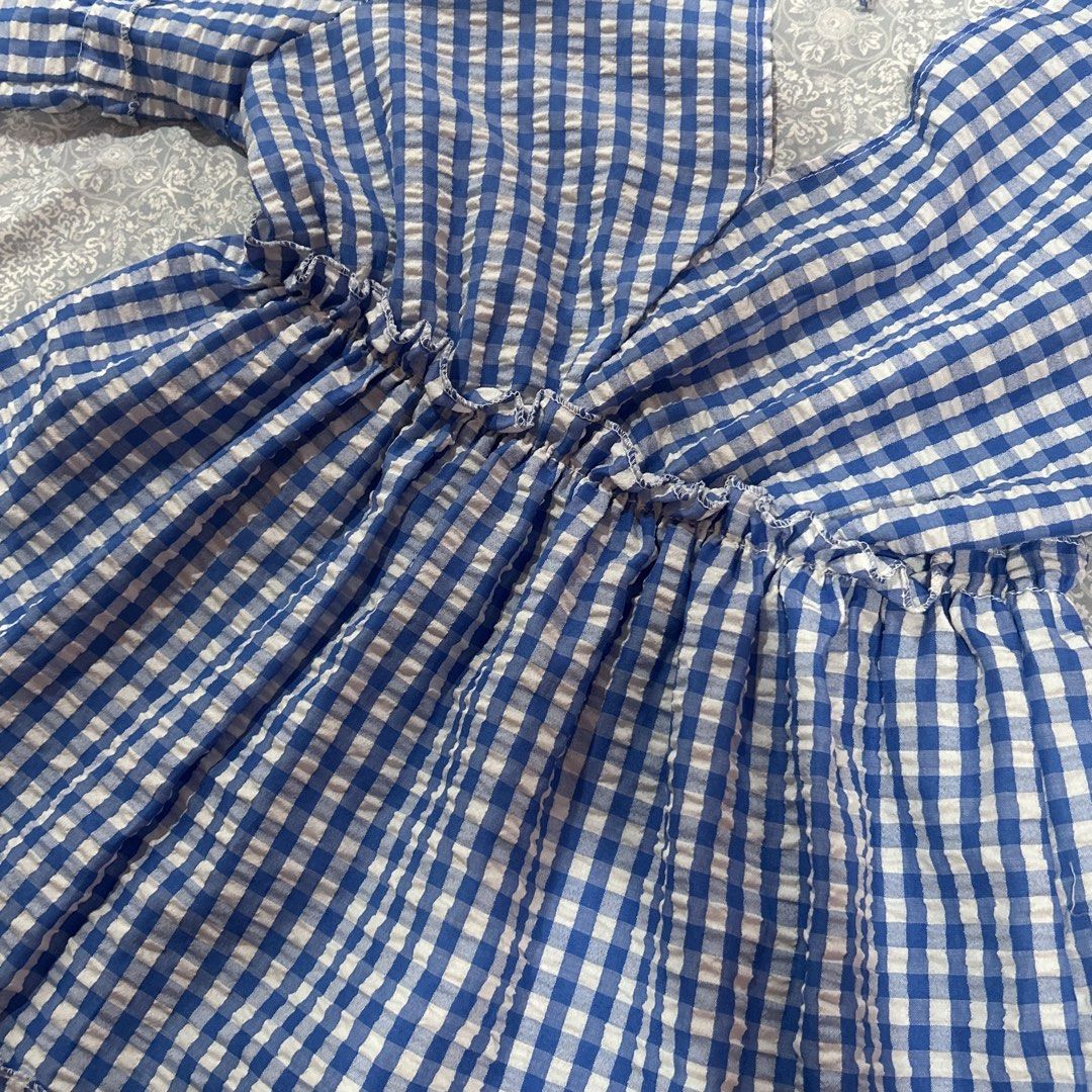 Blue Gingham Dress (Category: Dresses) located in Quezon City. Submitted by fishballer9000 (Listing ID 1439847383, Image 2). Description: Blue and white gingham patterned summer dress ! 🌀🤍 size: best fits M-L - V-neckline - Short sleeves with ruffled edges - Tiered skirt - Tie detail at back - Lightweight fabric - Ideal for warm weather.