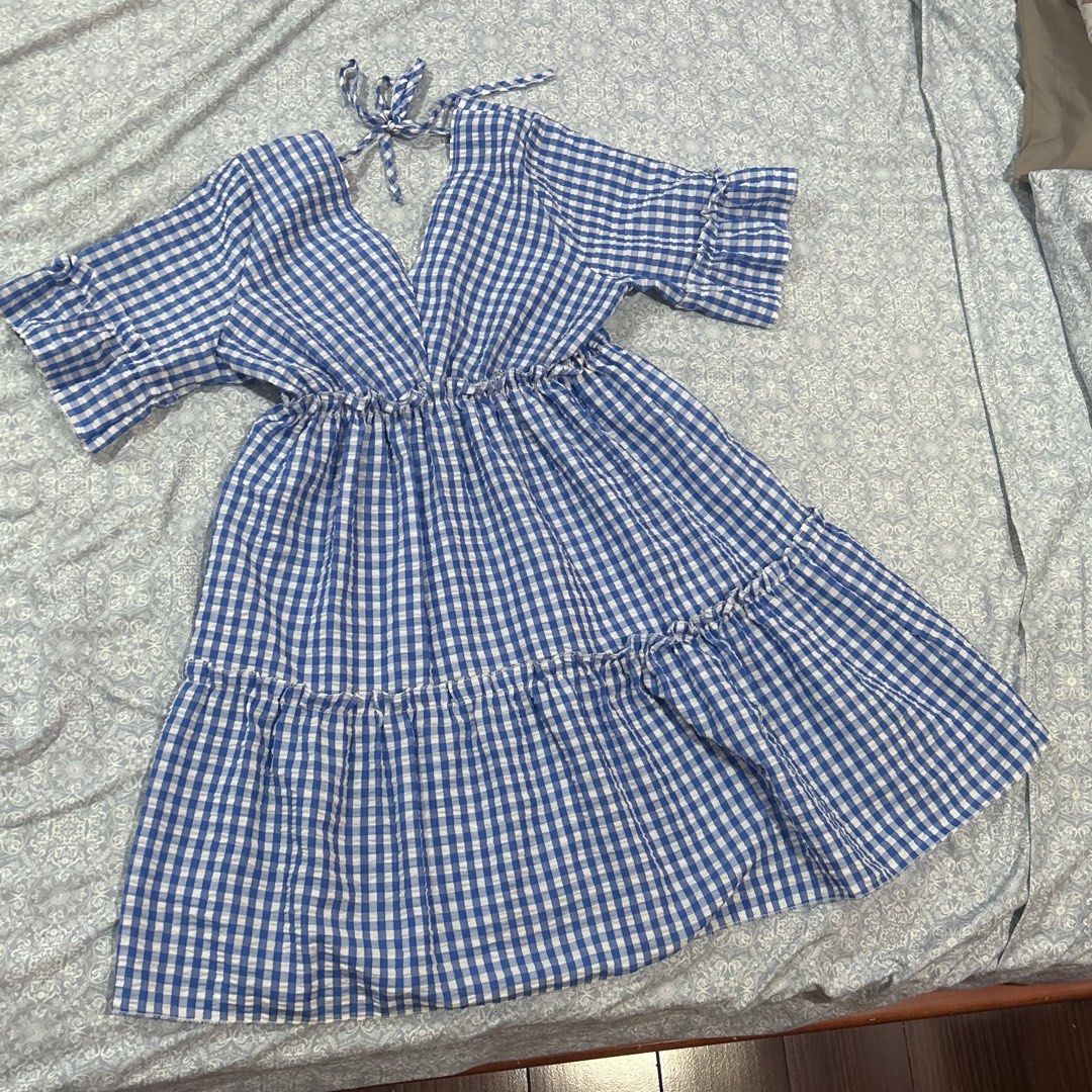 Blue Gingham Dress (Category: Dresses) located in Quezon City. Submitted by fishballer9000 (Listing ID 1439847383, Image 3). Description: Blue and white gingham patterned summer dress ! 🌀🤍 size: best fits M-L - V-neckline - Short sleeves with ruffled edges - Tiered skirt - Tie detail at back - Lightweight fabric - Ideal for warm weather.