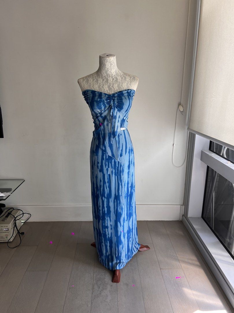 Blue Tie-Dye Strapless Maxi Dress (Category: Dresses) located in Makati City. Submitted by secondmuse_ (Listing ID 1439864974, Image 1). Description: - Strapless maxi dress - Unique blue tie-dye pattern - Ruched bodice with drawstring detail - Fitted silhouette - Lightweight fabric - Perfect for warm weather - Stylish and eye-catching.