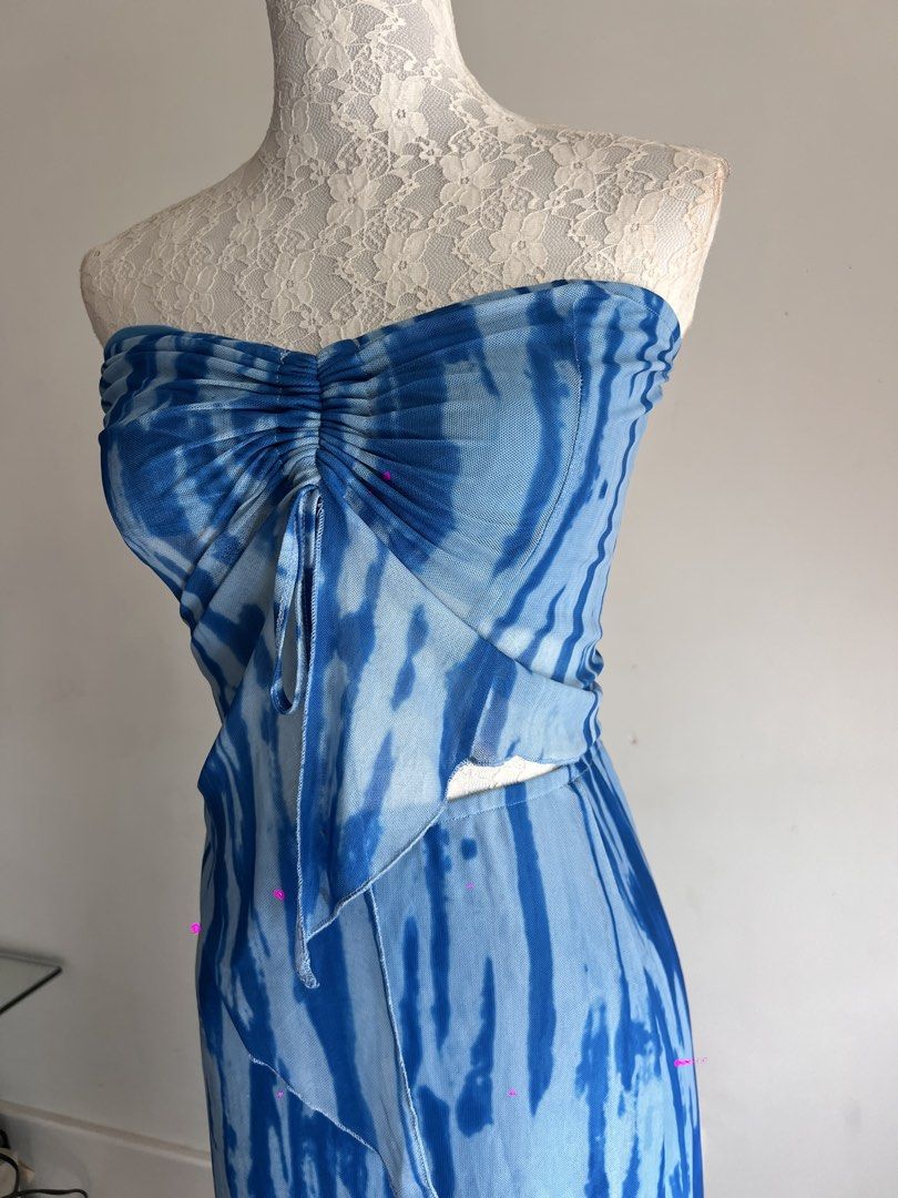 Blue Tie-Dye Strapless Maxi Dress (Category: Dresses) located in Makati City. Submitted by secondmuse_ (Listing ID 1439864974, Image 3). Description: - Strapless maxi dress - Unique blue tie-dye pattern - Ruched bodice with drawstring detail - Fitted silhouette - Lightweight fabric - Perfect for warm weather - Stylish and eye-catching.