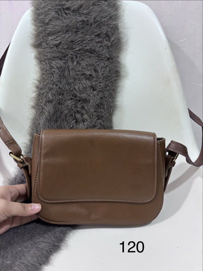 Brown Sling Bag (Category: Cross-body Bags) located in Quezon City. Submitted by makeitkmn (Listing ID 1439888114, Image 1). Description: - Brown sling bag - Flap closure - Long strap for crossbody wear - Smooth material - Medium size, perfect for everyday use.