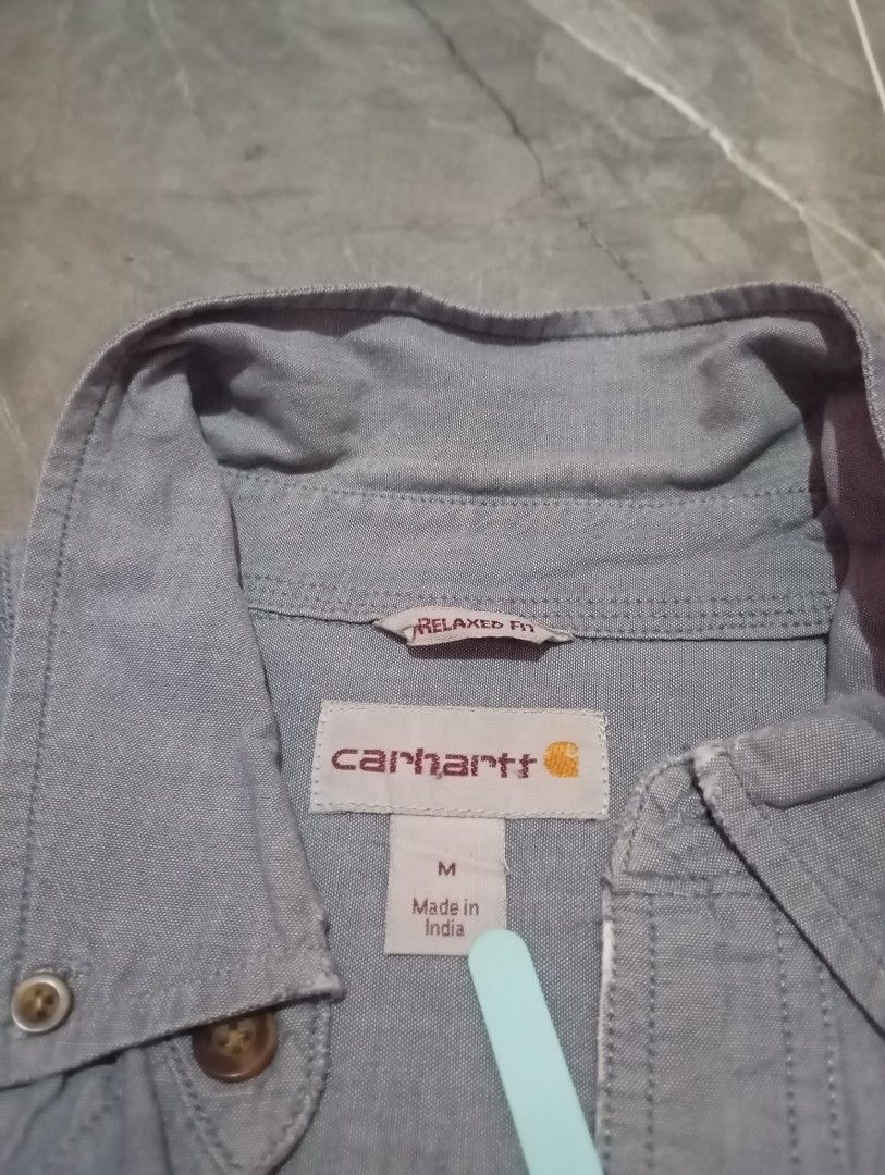 Carhartt Short Sleeve Shirt - Medium (Category: Tshirts & Polo Shirts ) located in Cotabato. Submitted by ysmaelcand84979 (Listing ID 1439840125, Image 3). Description: - Carhartt short sleeve shirt - Size: M - Relaxed fit - Features two chest pockets with button closures - Button-down front and collared neckline - Carhartt logo - Color: Light blue - Made in India.