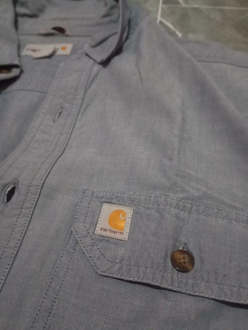 Carhartt Short Sleeve Shirt - Medium (Category: Tshirts & Polo Shirts ) located in Cotabato. Submitted by ysmaelcand84979 (Listing ID 1439840125, Image 2). Description: - Carhartt short sleeve shirt - Size: M - Relaxed fit - Features two chest pockets with button closures - Button-down front and collared neckline - Carhartt logo - Color: Light blue - Made in India.