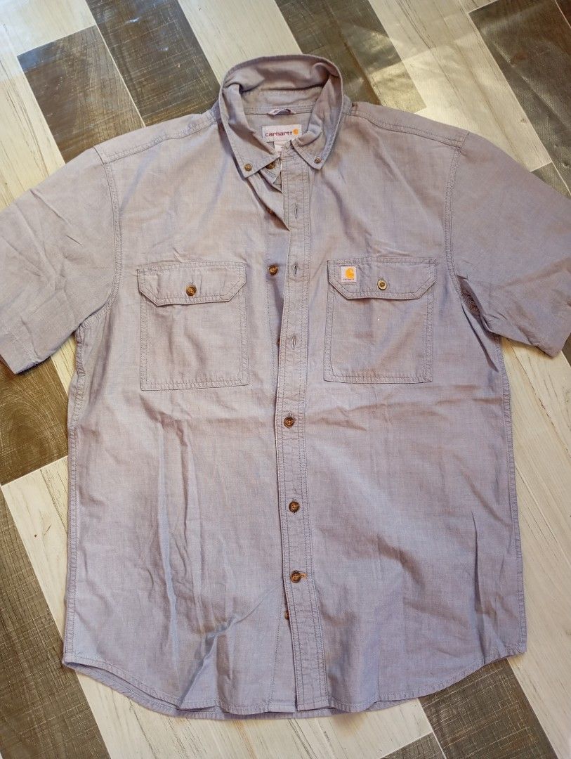 Carhartt Short Sleeve Shirt - Medium (Category: Tshirts & Polo Shirts ) located in Cotabato. Submitted by ysmaelcand84979 (Listing ID 1439840125, Image 1). Description: - Carhartt short sleeve shirt - Size: M - Relaxed fit - Features two chest pockets with button closures - Button-down front and collared neckline - Carhartt logo - Color: Light blue - Made in India.