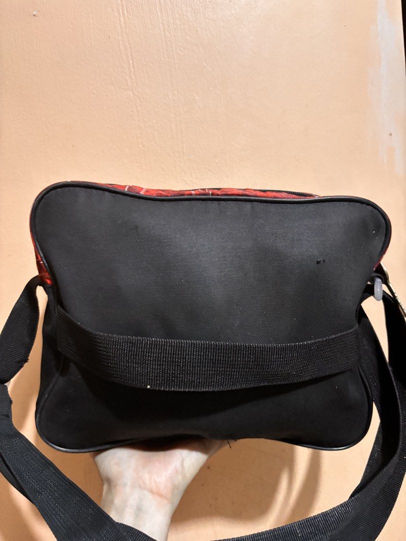 Cars Lightning McQueen Messenger Bag (Category: Babies & Kids Fashion) located in San Fernando. Submitted by ladychinita07 (Listing ID 1439814960, Image 3). Description: - Lightning McQueen design - Main compartment and front pocket - Side pocket for extra storage - Adjustable black strap - Secure zipper closure with key-shaped pulls - Durable red and black exterior.