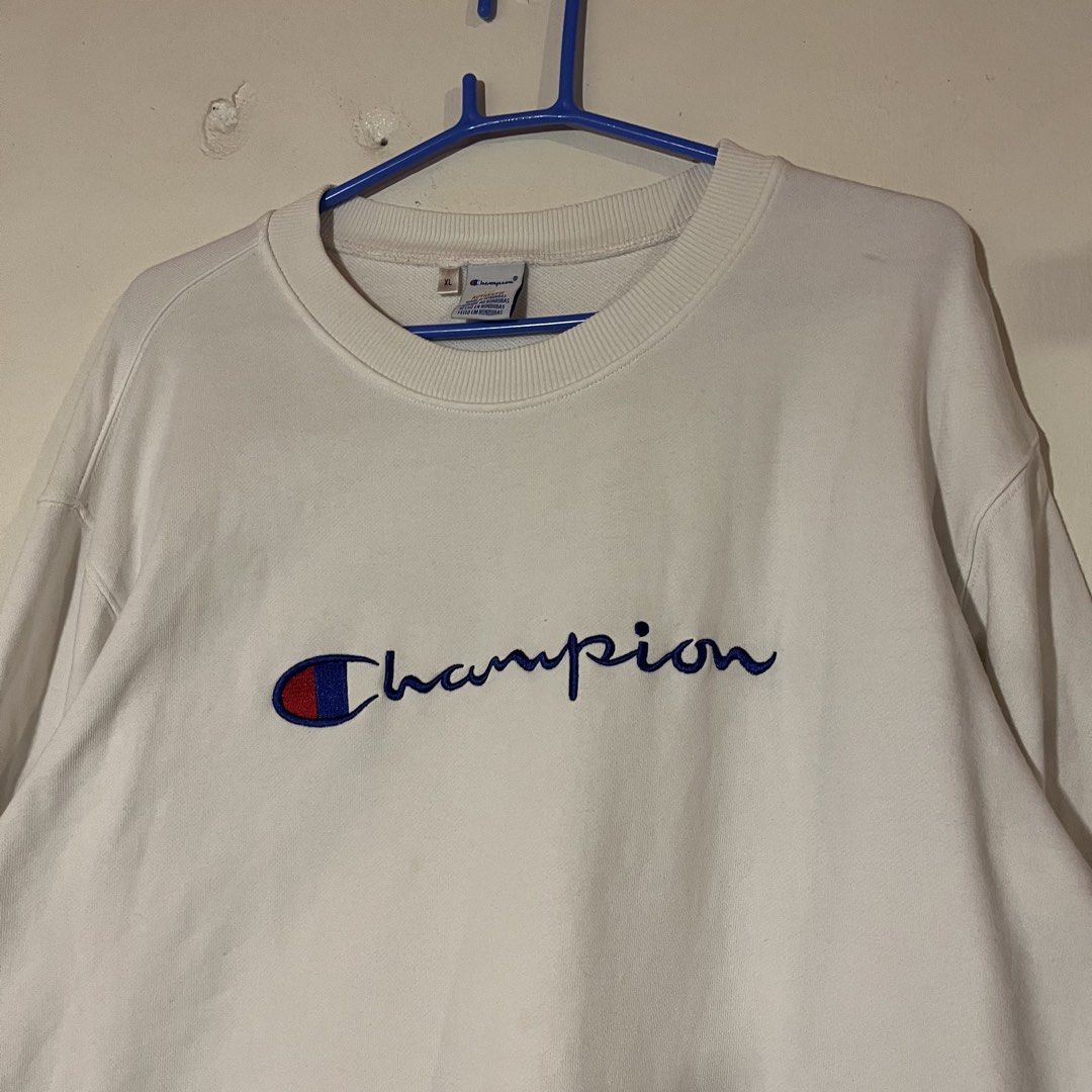 Champion | White Sweatshirt (Category: Coats, Jackets and Outerwear) located in Quezon City. Submitted by giometryyy (Listing ID 1439985071, Image 2). Description: L28 W22 XL on tag best fit L excellent condition already washed embroidered spell out 📍East Fairview, QC 🛵Lalamove / J&T payment first.