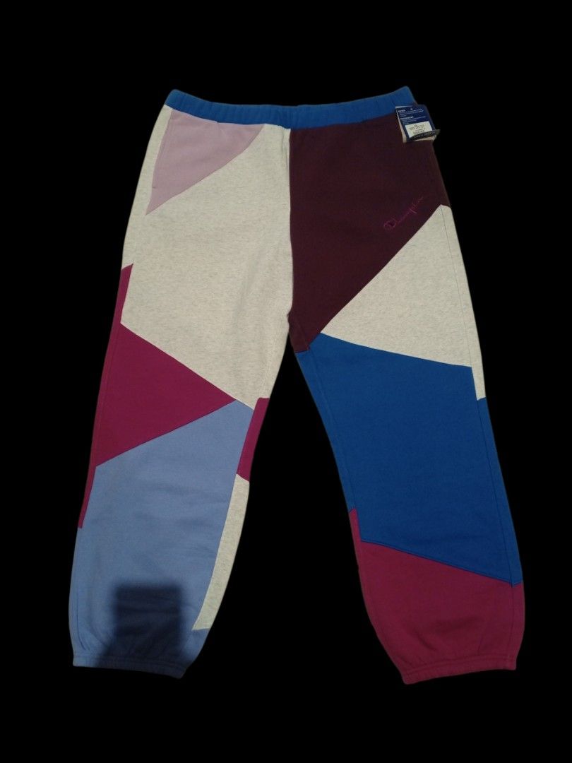 Champion Classic Fleece Patchwork Sweatpants 2X-Large (Category: Joggers) located in Guagua. Submitted by mrkrygn (Listing ID 1439948724, Image 1). Description: - Comfortable Champion sweatpants - Unique patchwork design in burgundy, blue, and grey - Made with classic fleece for warmth and softness - Features a drawstring waist for adjustable fit - Includes a convenient back pocket - Perfect for casual outings or lounging at home.
