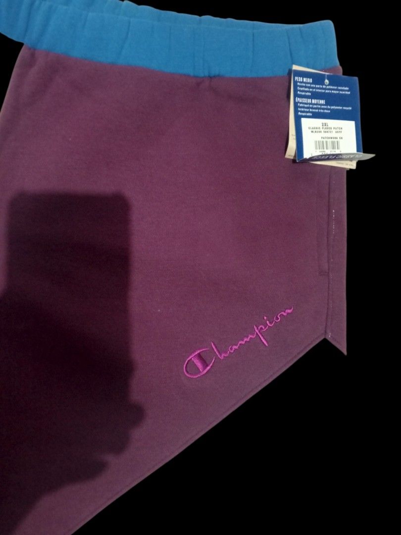 Champion Classic Fleece Patchwork Sweatpants 2X-Large (Category: Joggers) located in Guagua. Submitted by mrkrygn (Listing ID 1439948724, Image 3). Description: - Comfortable Champion sweatpants - Unique patchwork design in burgundy, blue, and grey - Made with classic fleece for warmth and softness - Features a drawstring waist for adjustable fit - Includes a convenient back pocket - Perfect for casual outings or lounging at home.