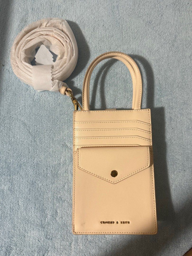 Charles & Keith Beige Card Holder Bag with Strap (Category: Cross-body Bags) located in Manila. Submitted by biancakesszz_ (Listing ID 1439982572, Image 1). Description: - Used once - Pm for more details and pics - Willing to give my personal acc for transactions .