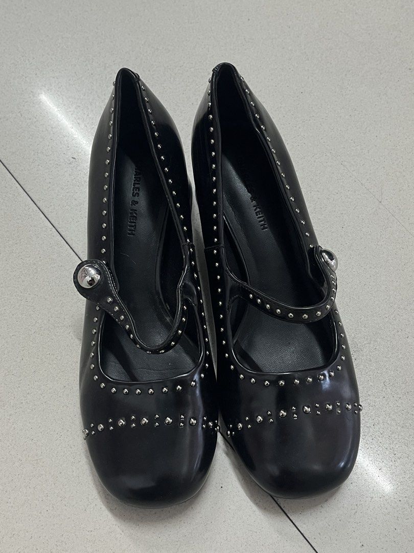 Charles & Keith Studded Mary Jane Heels (Category: Heels) located in Bulacan. Submitted by sef19 (Listing ID 1439836881, Image 1). Description: - Black Charles & Keith heels - Mary Jane style with strap - Studded details - Size 36 - Block heel - Glossy finish - Black soles with Charles & Keith branding.