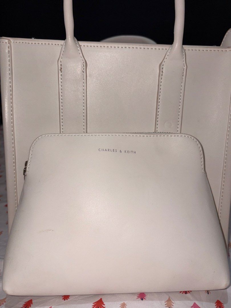 Charles & Keith White Tote Bag with Pouch (Category: Tote Bags) located in Manila. Submitted by fierce_denclutter (Listing ID 1439939209, Image 2). Description: - Stylish white Charles & Keith tote bag - Subtle embossed brand name on the side - Comes with a matching zippered pouch - Spacious, lined interior - Detachable shoulder strap for versatile carrying.