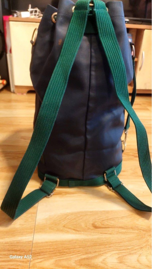 Classic Lacoste Bucket Bag Navy Blue Green Drawstring (Category: Luxury Bags & Wallets) located in Caloocan City. Submitted by juana_finds26 (Listing ID 1439936211, Image 3). Description: - Authentic Lacoste bucket bag - Color: Navy blue with green accents - Closure: Drawstring - Pockets: Front zippered pocket - Straps: Adjustable shoulder straps - Origin: Made in France - Ideal for: Everyday use or travel.