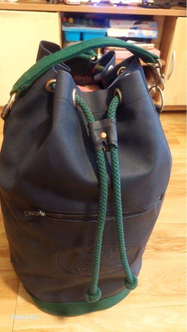Classic Lacoste Bucket Bag Navy Blue Green Drawstring (Category: Luxury Bags & Wallets) located in Caloocan City. Submitted by juana_finds26 (Listing ID 1439936211, Image 2). Description: - Authentic Lacoste bucket bag - Color: Navy blue with green accents - Closure: Drawstring - Pockets: Front zippered pocket - Straps: Adjustable shoulder straps - Origin: Made in France - Ideal for: Everyday use or travel.