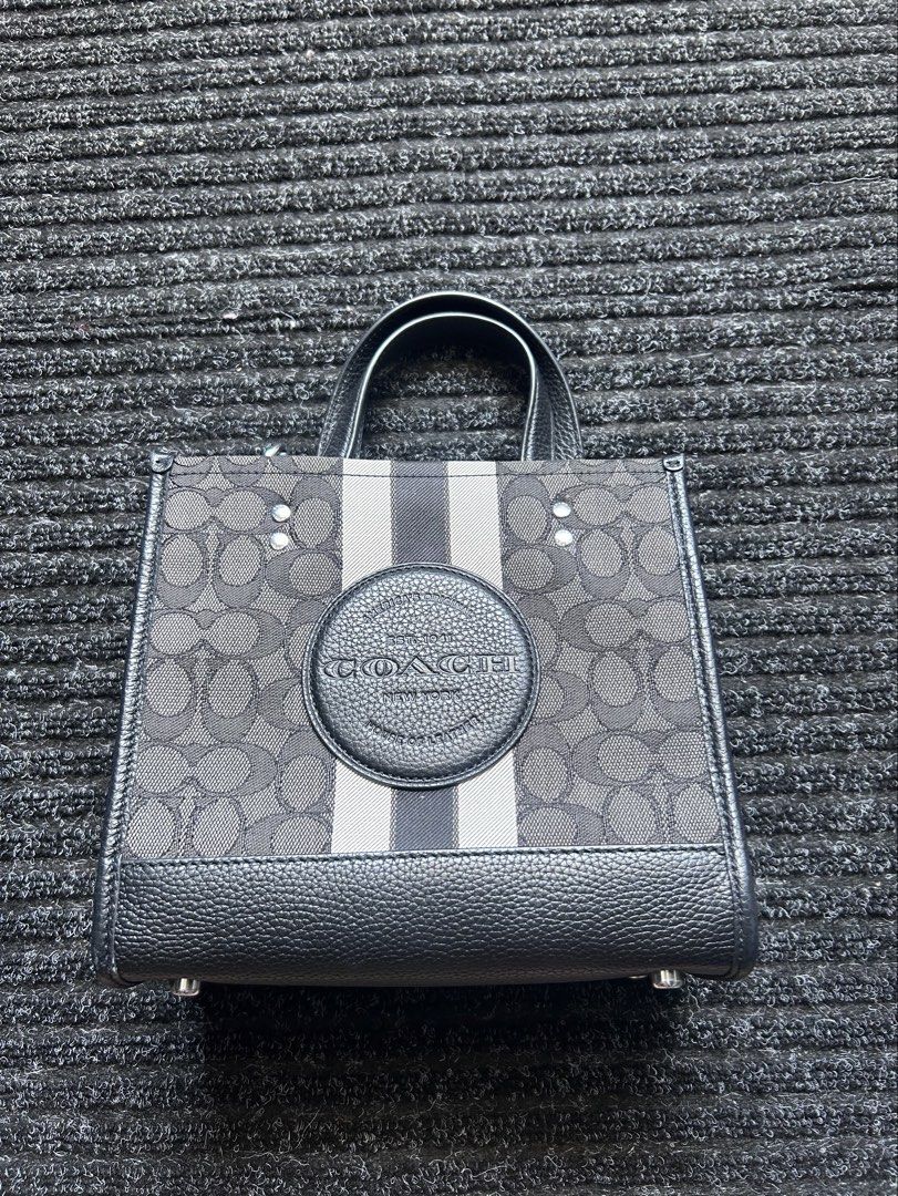 Coach Dempsey Tote 22 (Category: Luxury Bags & Wallets) located in Pasig City. Submitted by califinestcollectibles (Listing ID 1439829987, Image 1). Description: Coach Dempsey Tote 22 in black signature jacquard with a central stripe and patch. Height: 20 cm Width: 12cm Length: 22cm Original/Authentic Actual and Detailed Pictures are Posted Pick Up at One Oasis condominium ortigas extension pasig city Or Delivery via Lalamove,Jnt, LBC cod/cop JNT