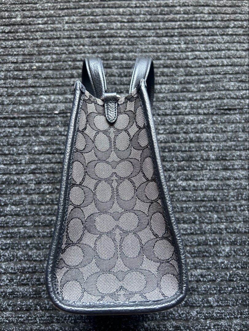 Coach Dempsey Tote 22 (Category: Luxury Bags & Wallets) located in Pasig City. Submitted by califinestcollectibles (Listing ID 1439829987, Image 3). Description: Coach Dempsey Tote 22 in black signature jacquard with a central stripe and patch. Height: 20 cm Width: 12cm Length: 22cm Original/Authentic Actual and Detailed Pictures are Posted Pick Up at One Oasis condominium ortigas extension pasig city Or Delivery via Lalamove,Jnt, LBC cod/cop JNT