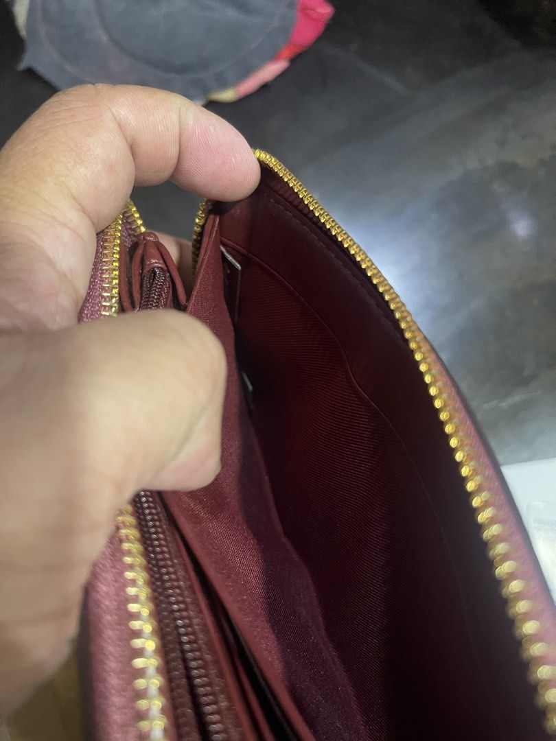 Coach Signature Zip Around Wallet (Category: Wallets & Card holders) located in Mandaluyong City. Submitted by mark2pac (Listing ID 1439941163, Image 2). Description: - Authentic Coach zip-around wallet - Signature C pattern in brown and tan - Shimmering metallic purple top accent - Deep burgundy interior with multiple card slots and compartments - Gold-tone hardware and zipper closure.