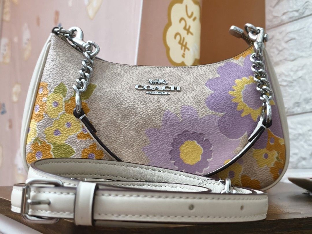 Coach Teri (Category: Luxury Bags & Wallets) located in Ormoc. Submitted by jonaprelove (Listing ID 1439840887, Image 2). Description: - Coach shoulder bag - Beautiful floral print design - Includes chain strap and adjustable strap - Beige base with colorful floral accents - White side panels - Coach logo on front - Stylish and versatile.